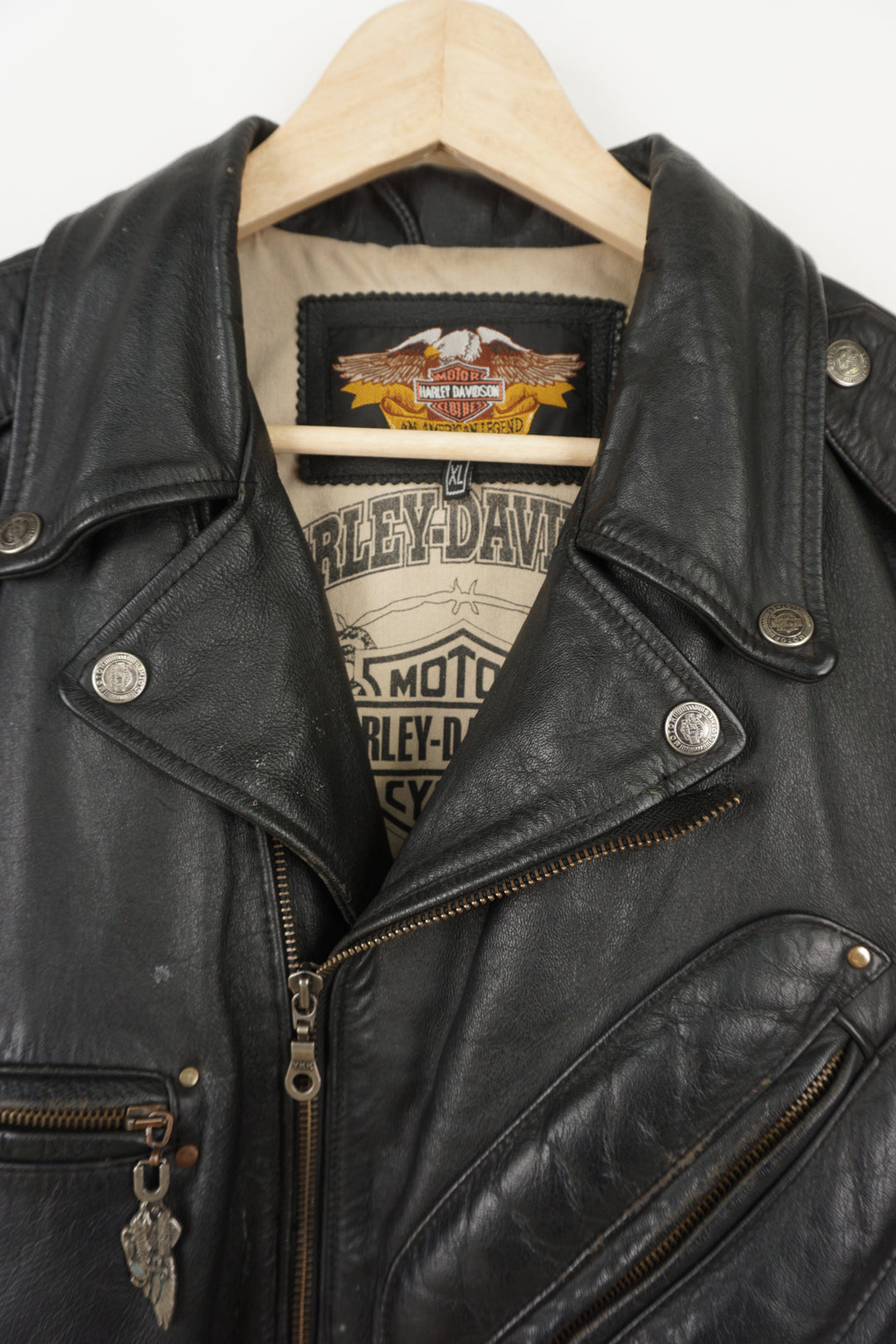 Vintage Harley Davidson black leather motorcycle jacket with embossed eagle design, embroidered badges and multiple pockets