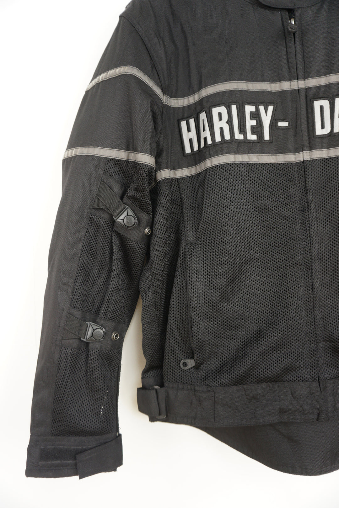 Harley Davidson classic cruiser black mesh riding jacket with removable pads in the shoulder and elbows. With embroidered spell-out details across the chest and on the back