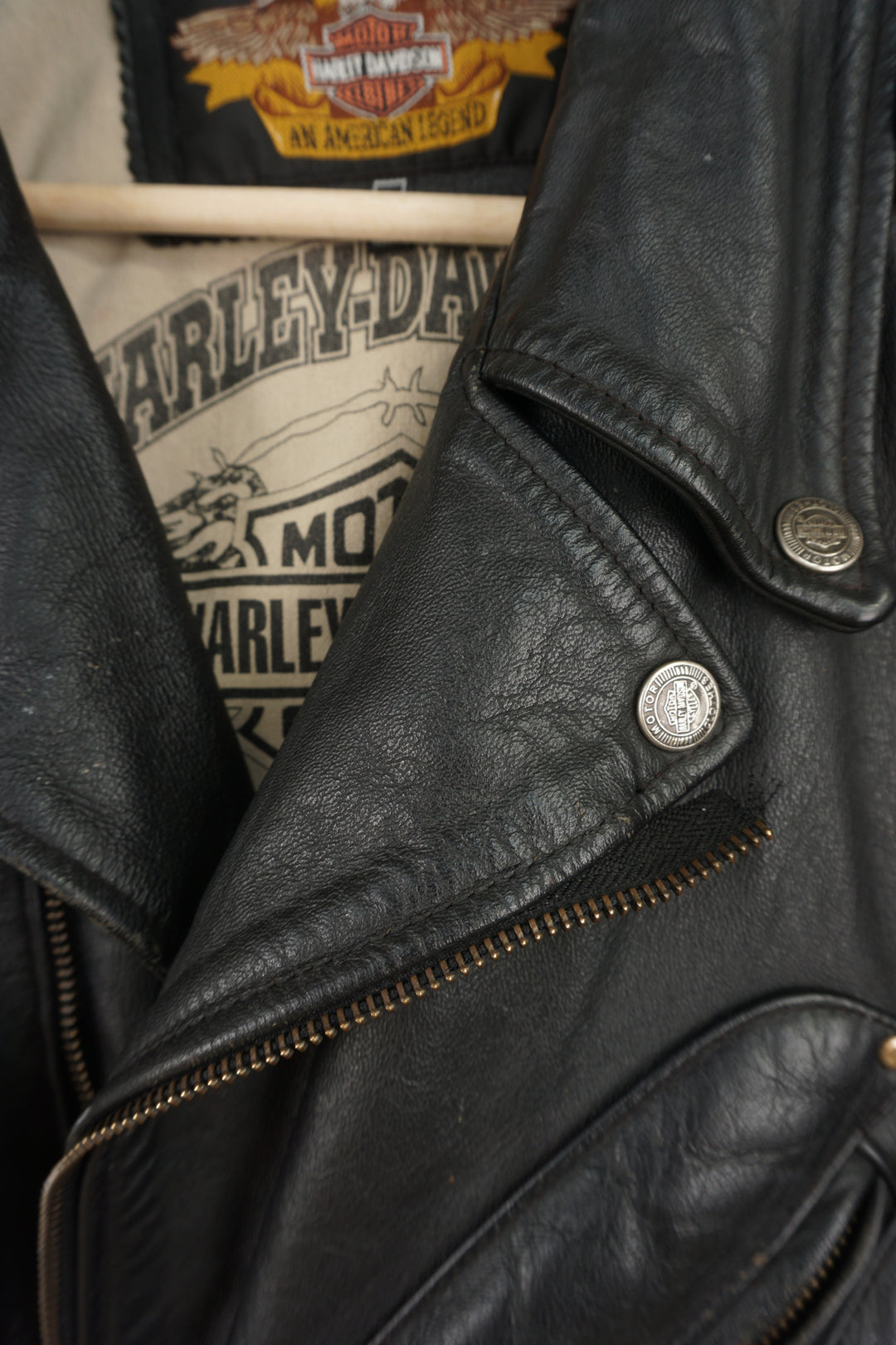 Vintage Harley Davidson black leather motorcycle jacket with embossed eagle design, embroidered badges and multiple pockets