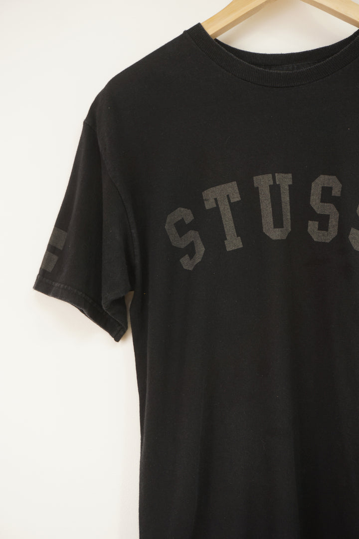 Vintage Stussy black t-shirt, with spell-out graphic on the front and back