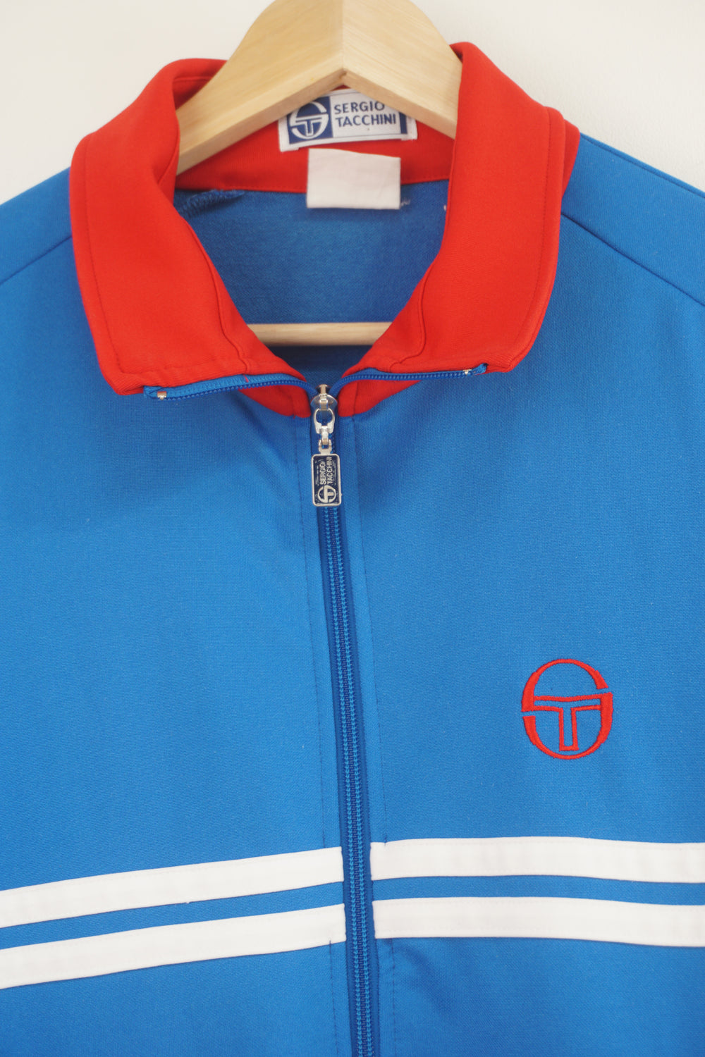 Vintage 80's Casual Sergio Tacchini blue tracksuit top with embroidered logo on the chest and white stripe details 