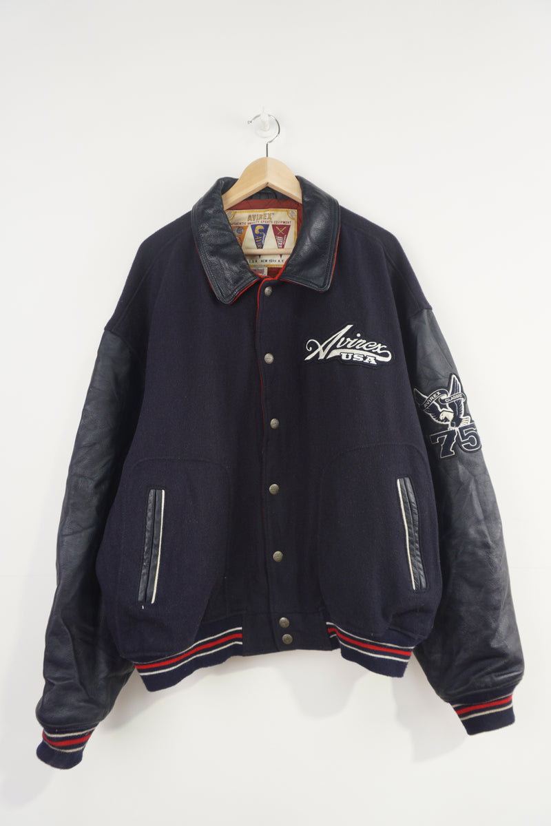 Vintage Avirex USA navy blue Varsity Jacket, embroidered badges on front, sleeve, and back. 