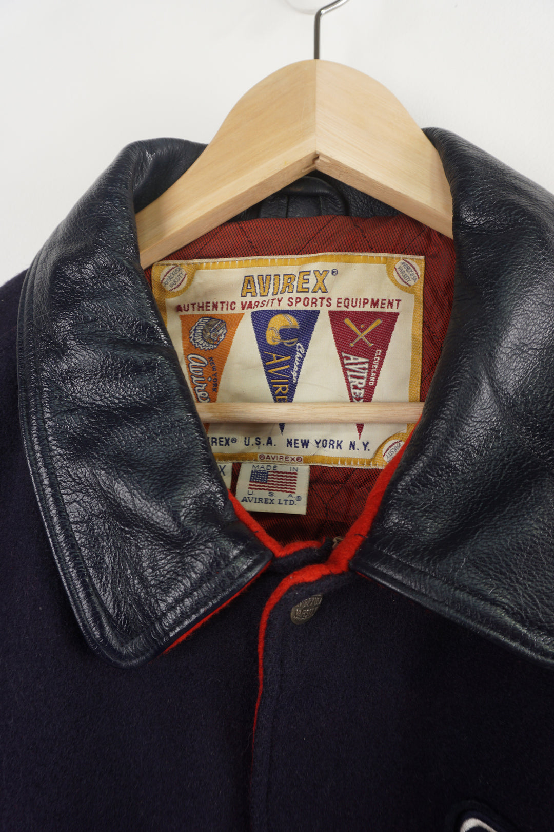 Vintage Avirex USA navy blue Varsity Jacket, embroidered badges on front, sleeve, and back. 