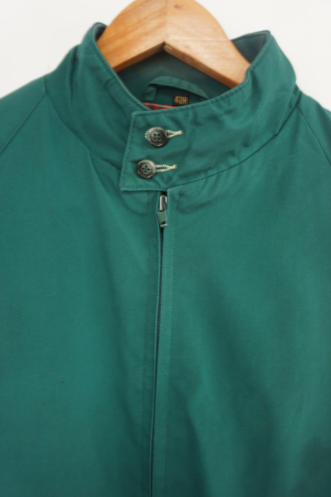 Green Baracuta harrington jacket, with elasticated waist and cuffs, red plaid lining