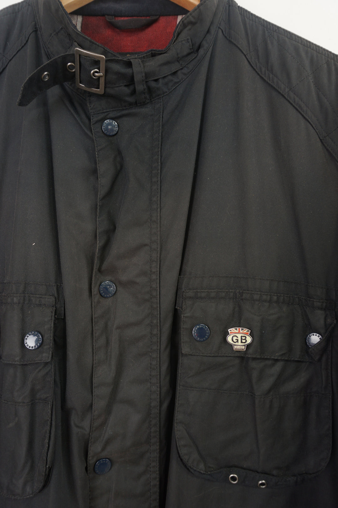 Barbour International wax jacket with multiple pockets and signature logo on the sleeve