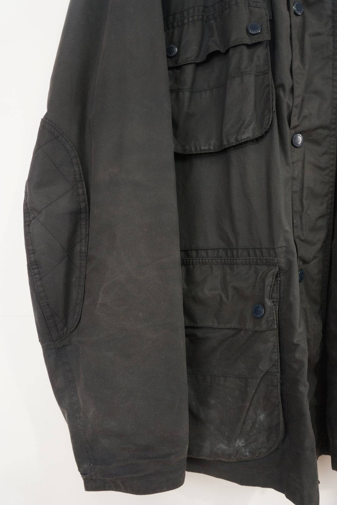 Barbour International wax jacket with multiple pockets and signature logo on the sleeve