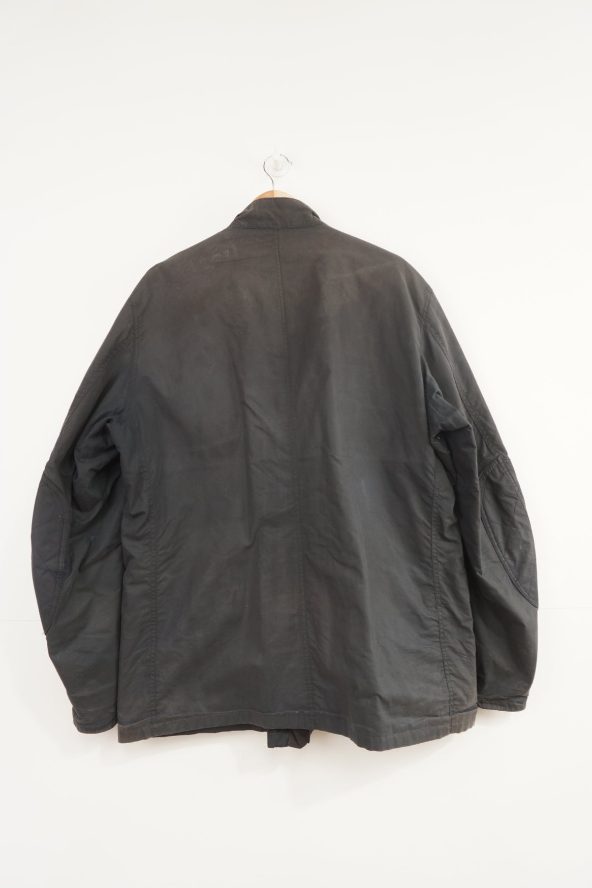 Barbour International wax jacket with multiple pockets and signature logo on the sleeve