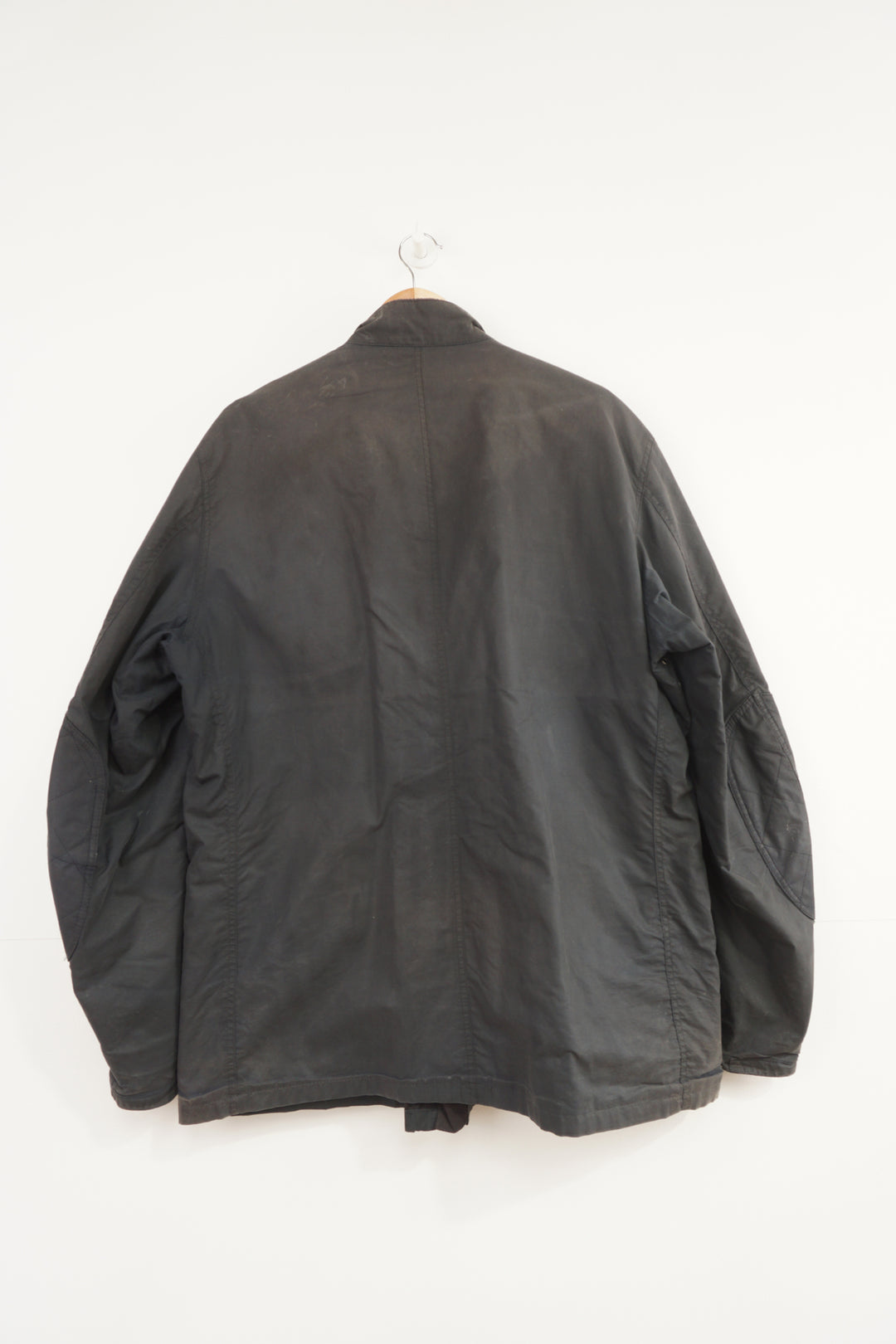 Barbour International wax jacket with multiple pockets and signature logo on the sleeve