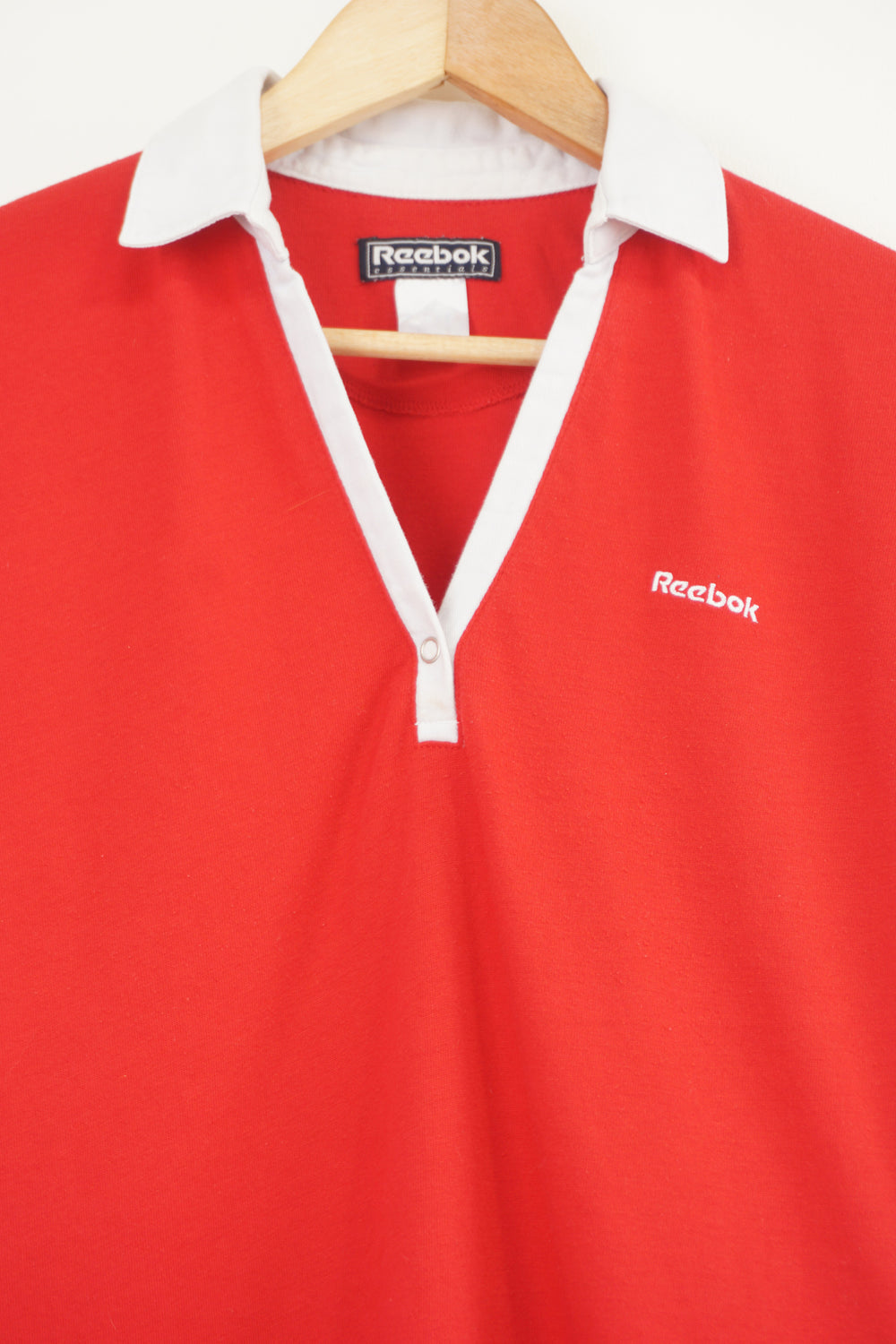 Red and white Reebok baby tee style v-neck t-shirt with embroidered logo on the chest