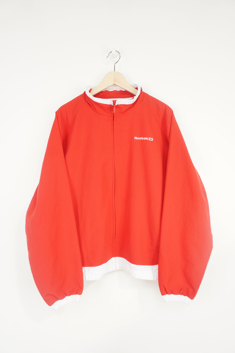 All red Reebok zip through track jacket with embroidered logo on the chest