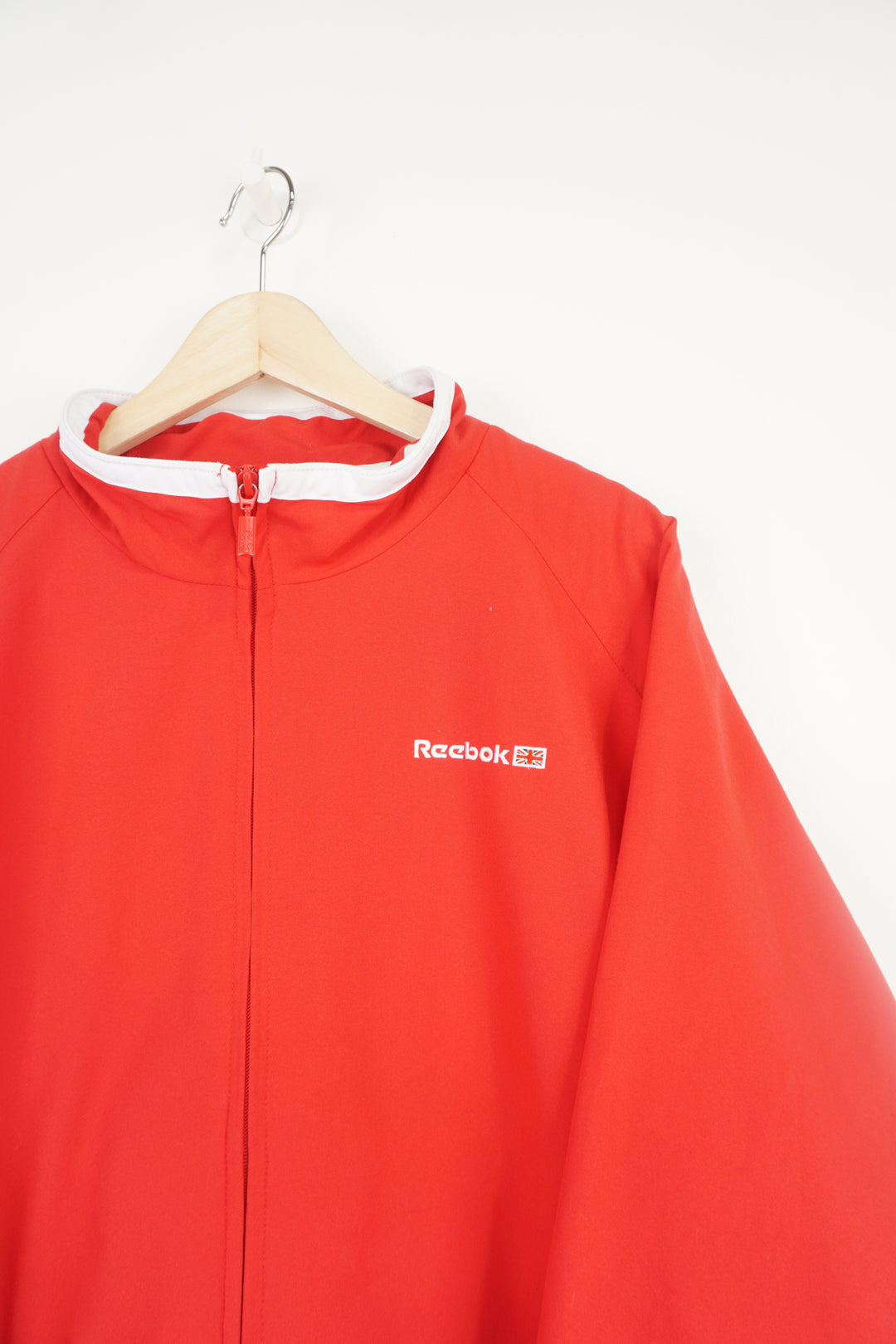 All red Reebok zip through track jacket with embroidered logo on the chest