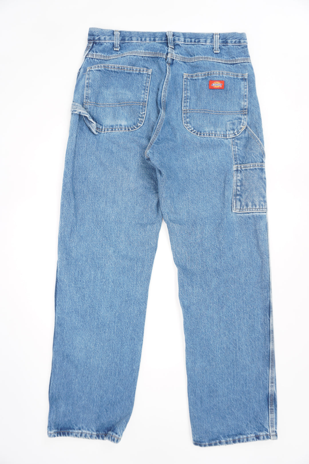 Dickies blue carpenter jeans with multiple pockets and signature logo on the back pocket