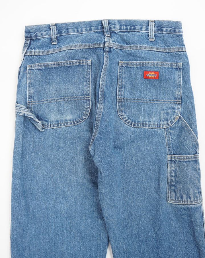 Dickies blue carpenter jeans with multiple pockets and signature logo on the back pocket