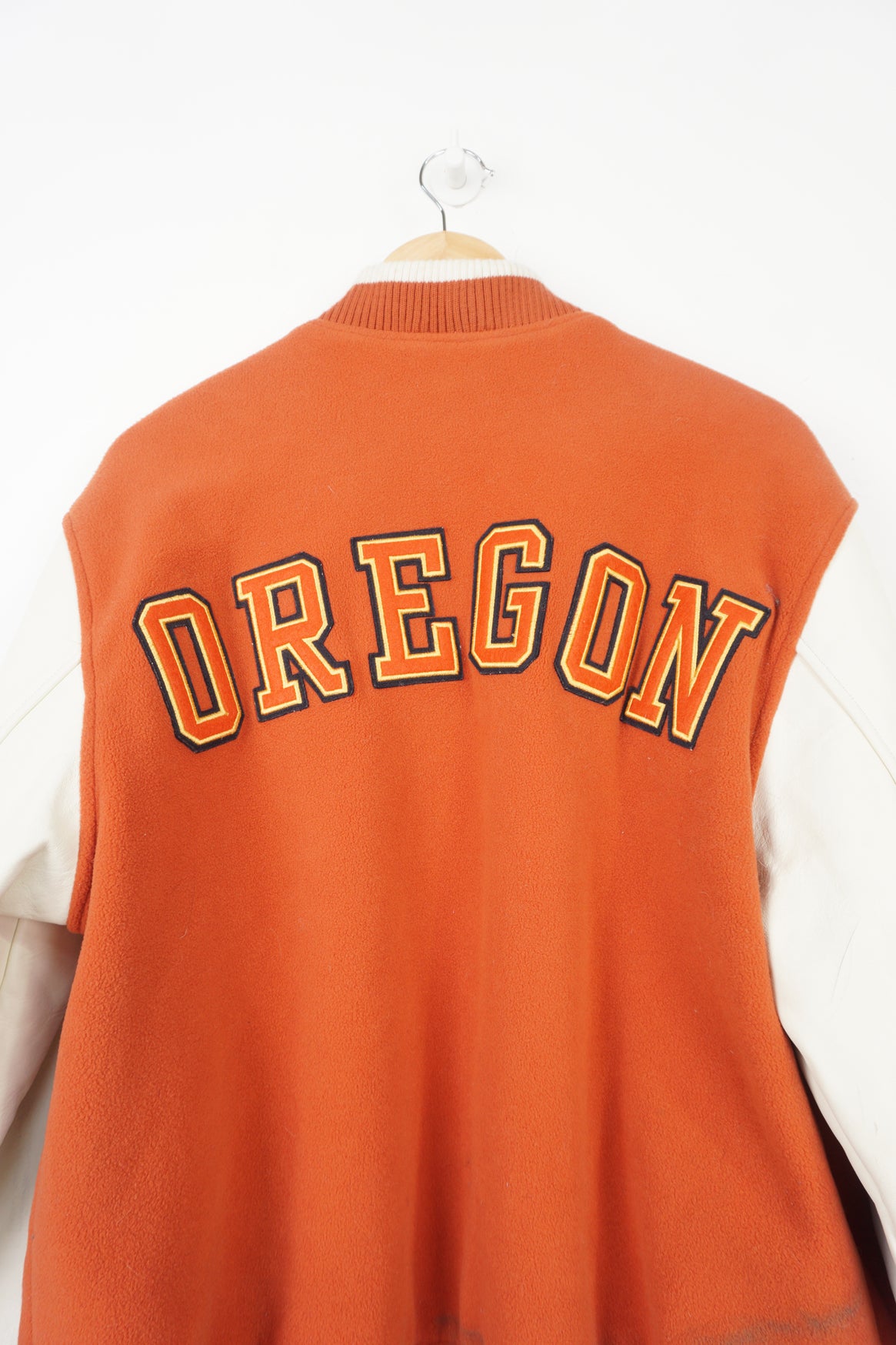 Vintage Nike Oregon orange and white fleece varsity jacket with leather sleeves and embroidered spell-out details