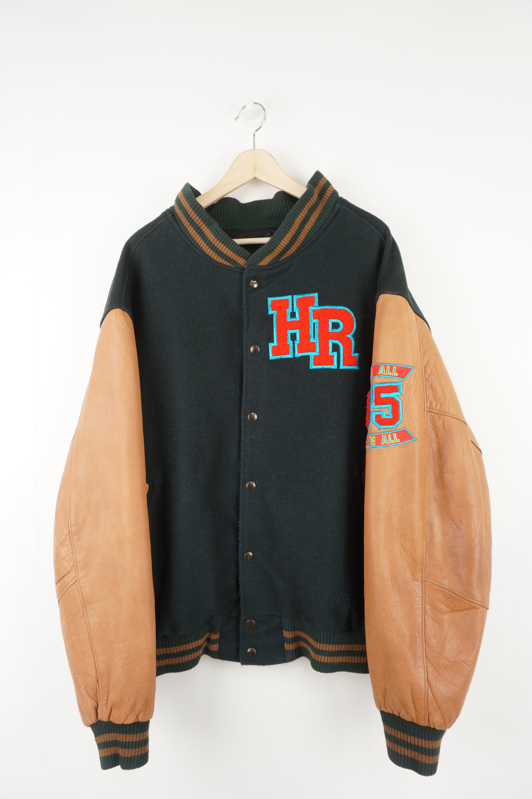 Vintage green wool Hard Rock Hotel Las Vegas varsity jacket with brown leather sleeves.