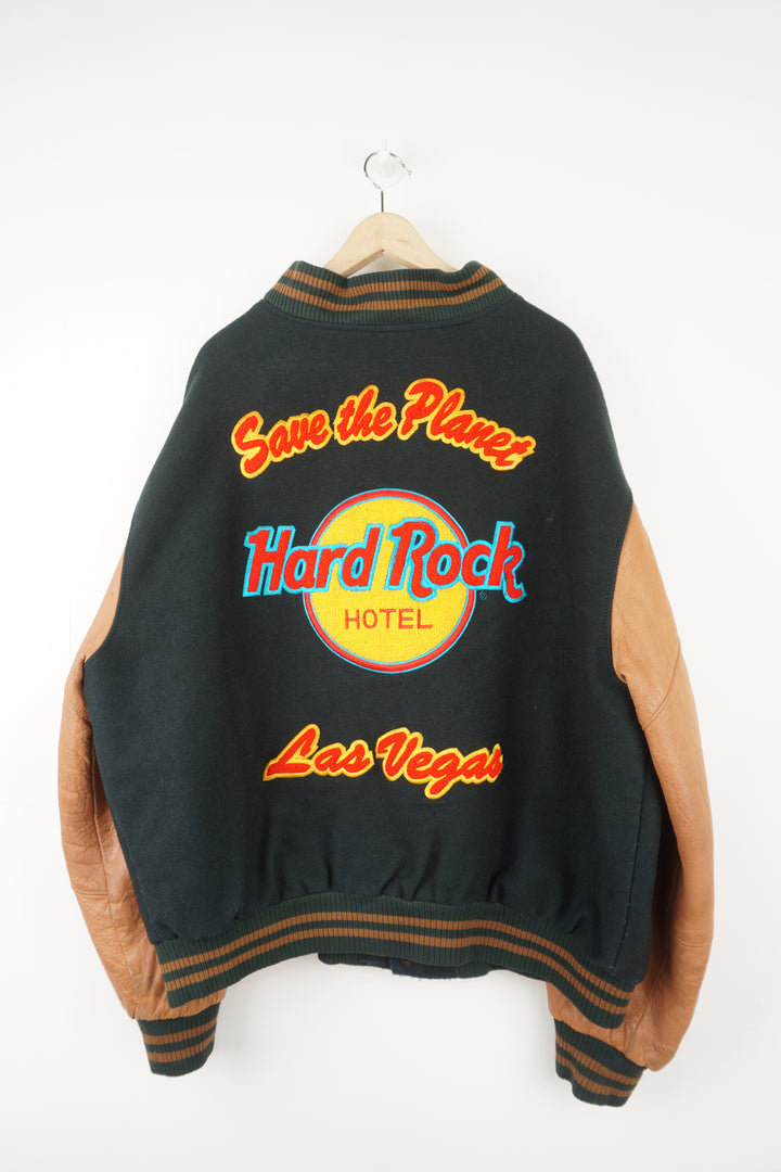 Vintage green wool Hard Rock Hotel Las Vegas varsity jacket with brown leather sleeves.