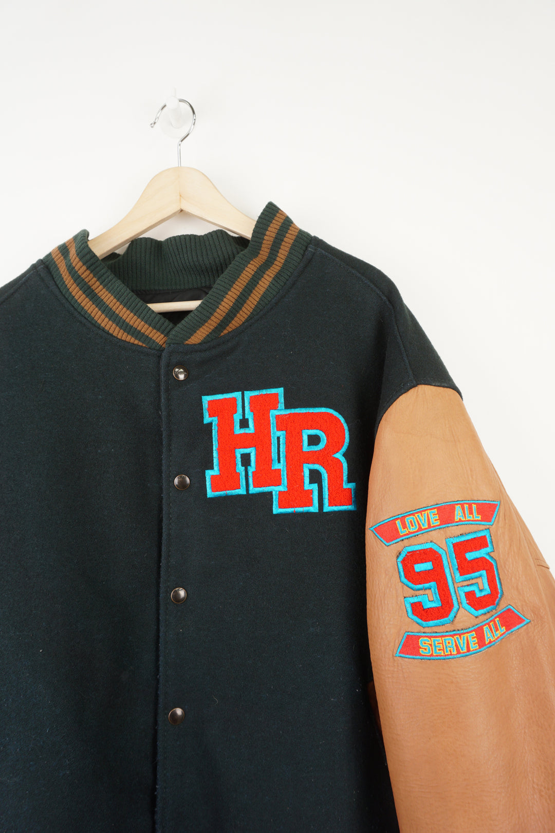 Vintage green wool Hard Rock Hotel Las Vegas varsity jacket with brown leather sleeves.