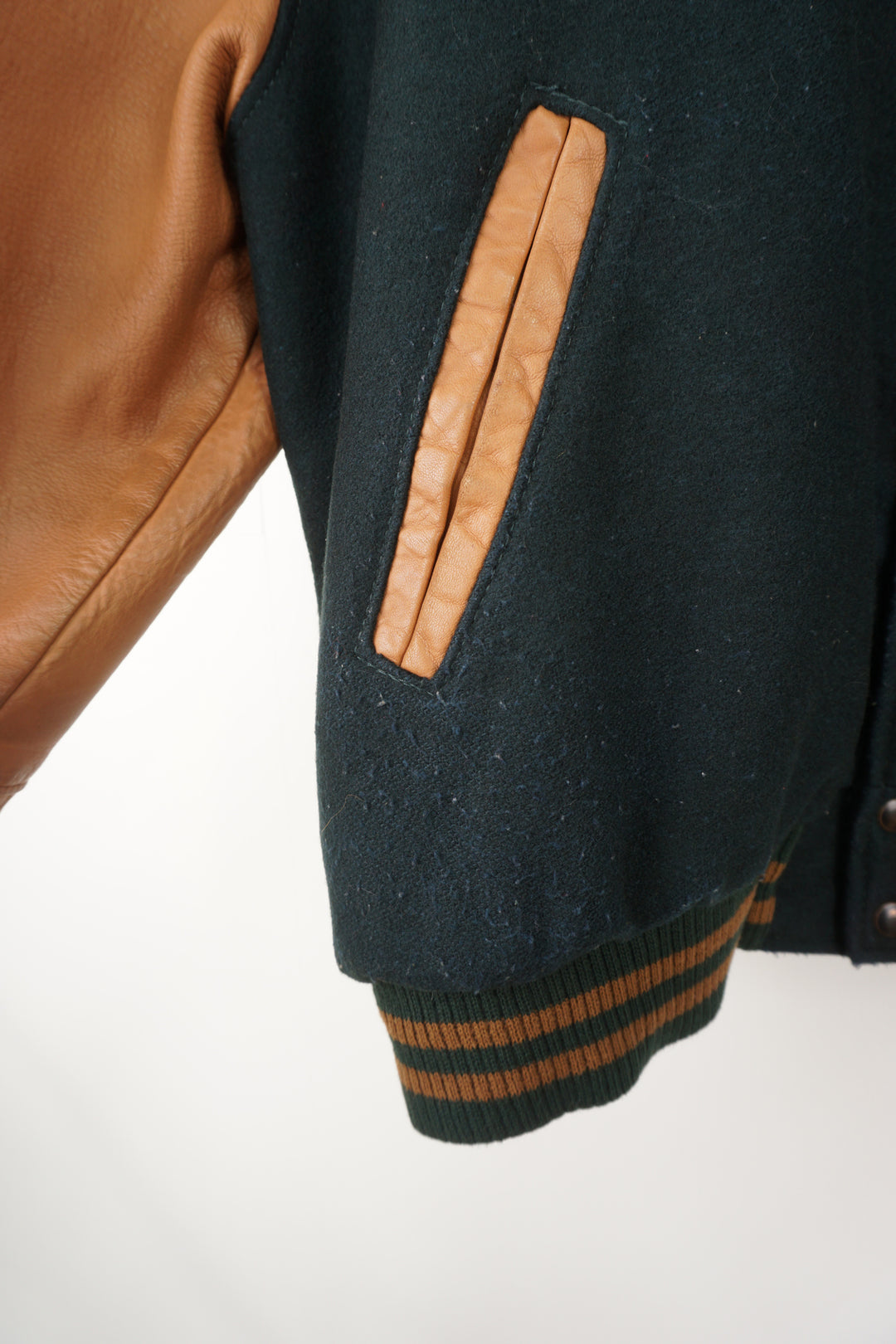 Vintage green wool Hard Rock Hotel Las Vegas varsity jacket with brown leather sleeves.