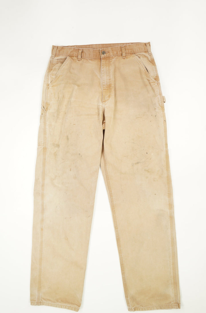 Tan Carhartt carpenter style jeans with multiple pockets