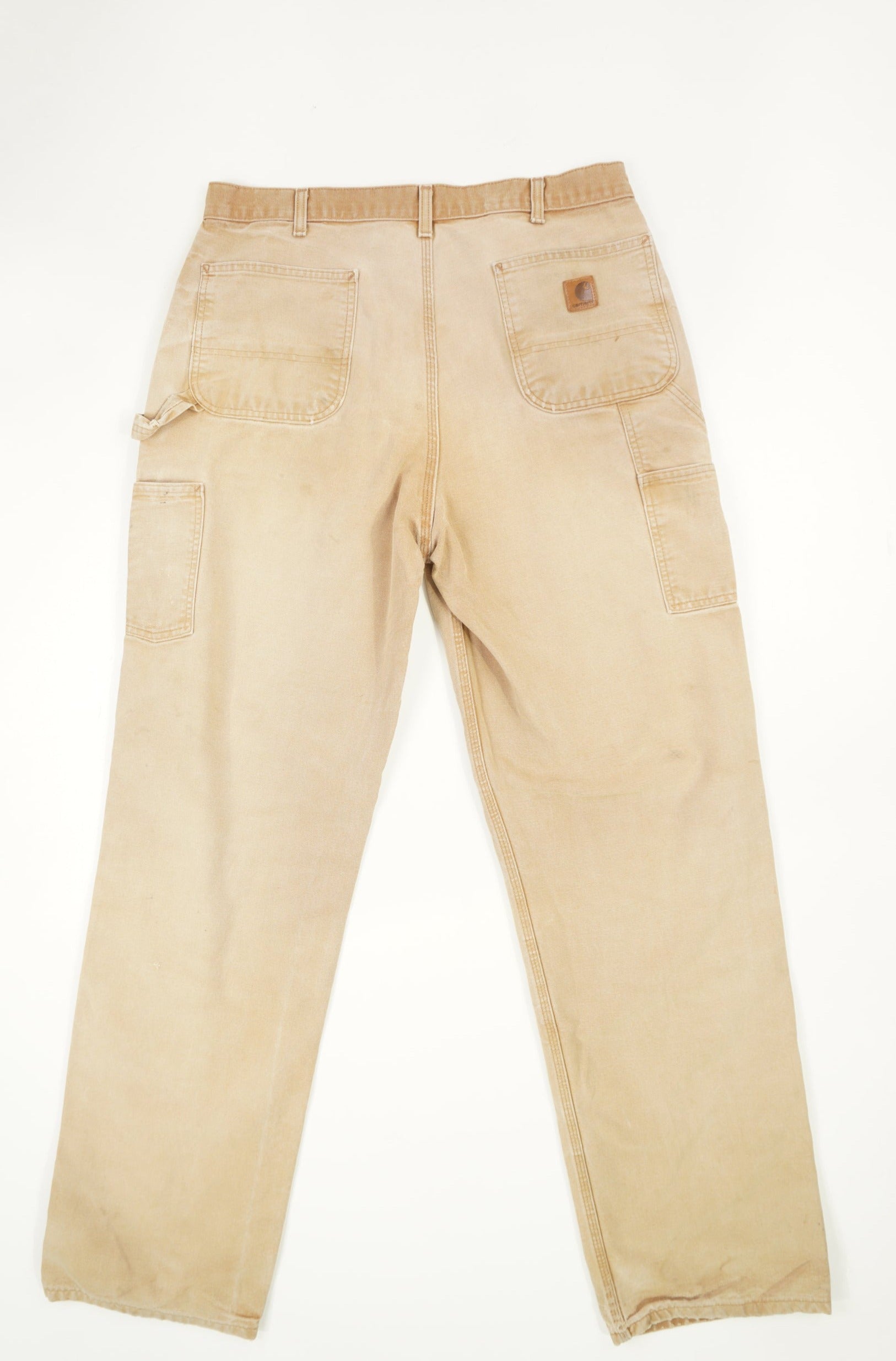 Tan Carhartt carpenter style jeans with multiple pockets