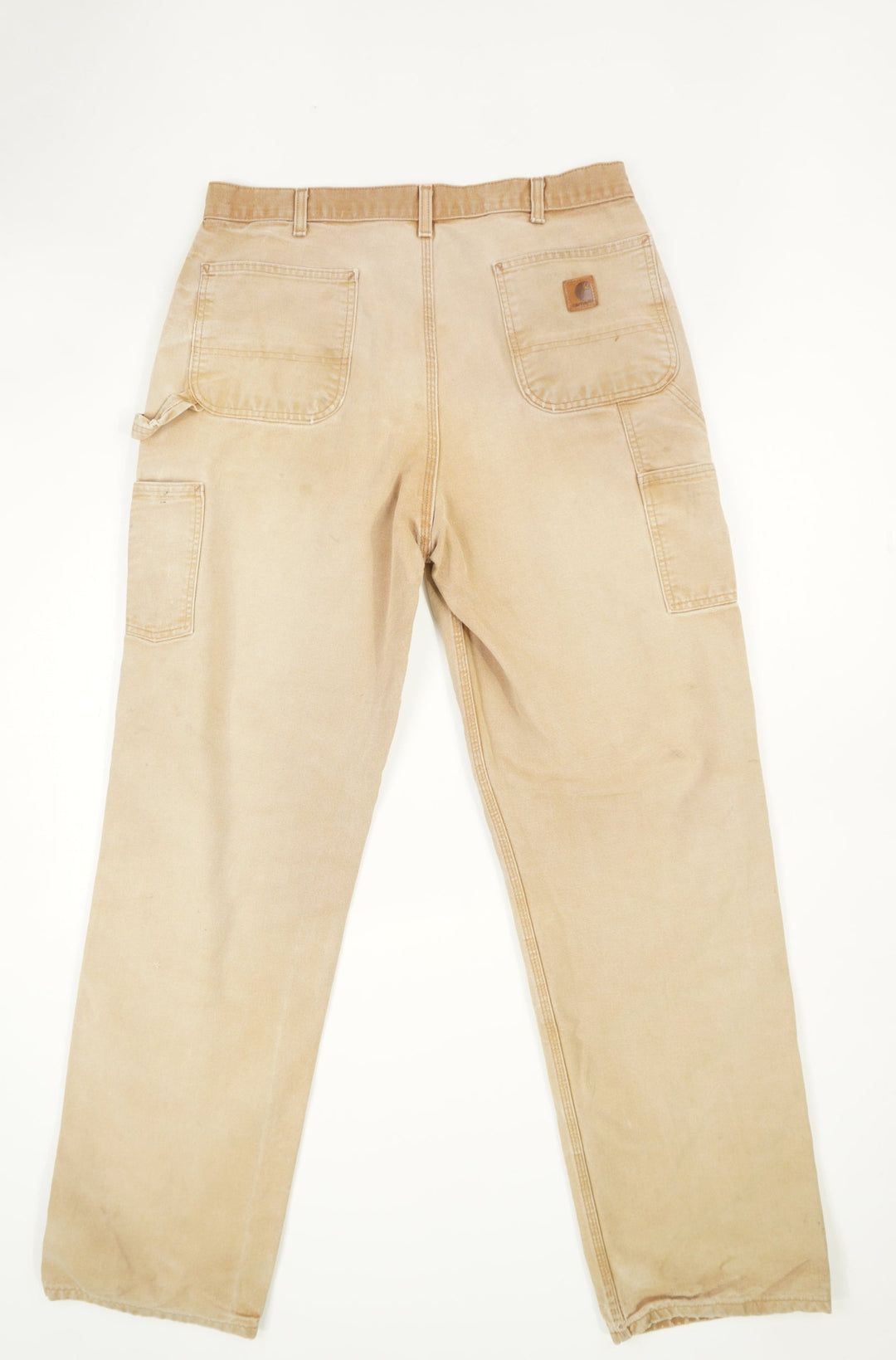 Tan Carhartt carpenter style jeans with multiple pockets