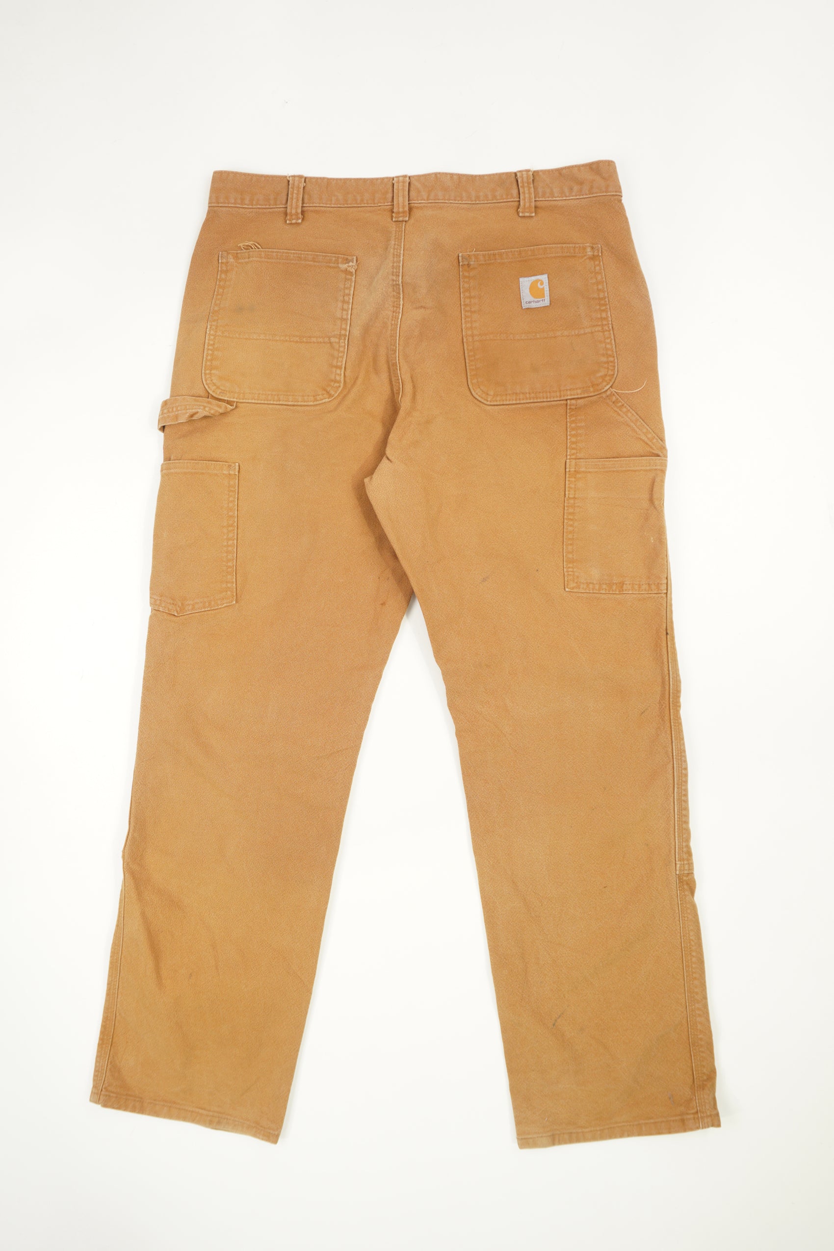 Tan Carhartt double knee carpenter style jeans with multiple pockets