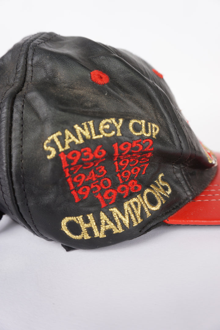 Vintage 1998 Stanley Cup NHL champions: Detroit Red Wings black leather baseball features embroidered badges on the front and sides