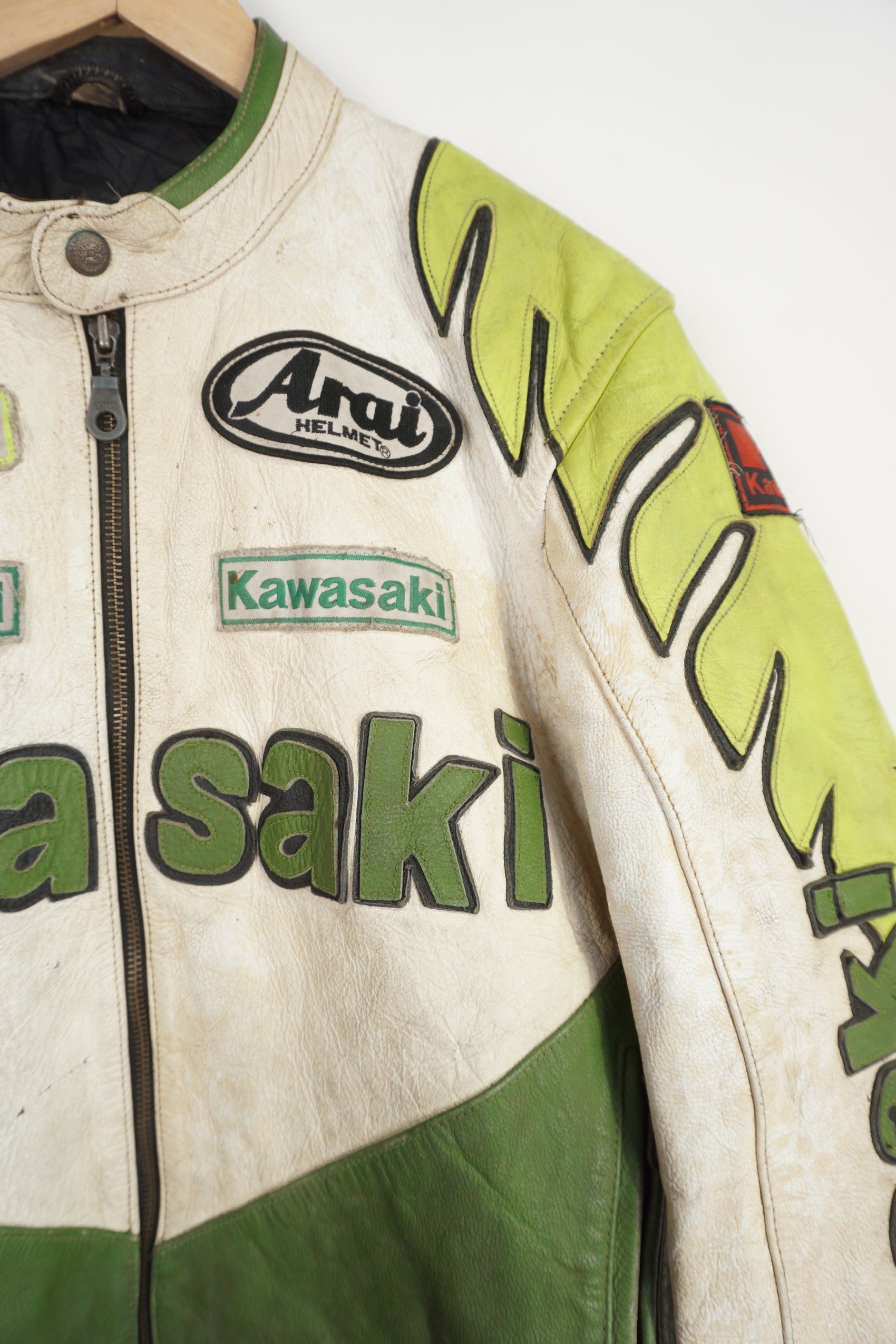 Vintage Kawasaki green & white leather motorcycle jacket features embroidered spell-out details, badges and sponsors