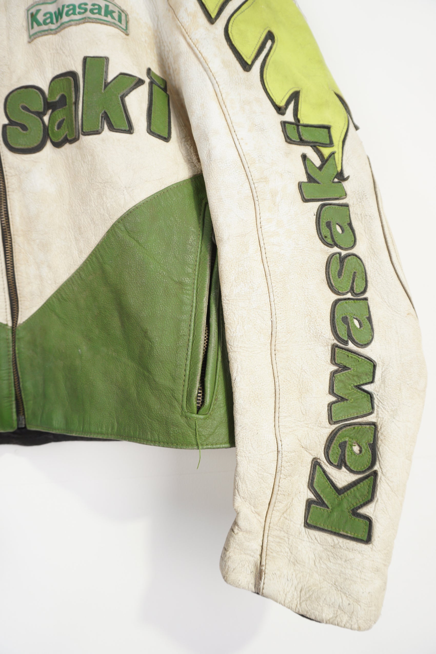 Vintage Kawasaki green & white leather motorcycle jacket features embroidered spell-out details, badges and sponsors