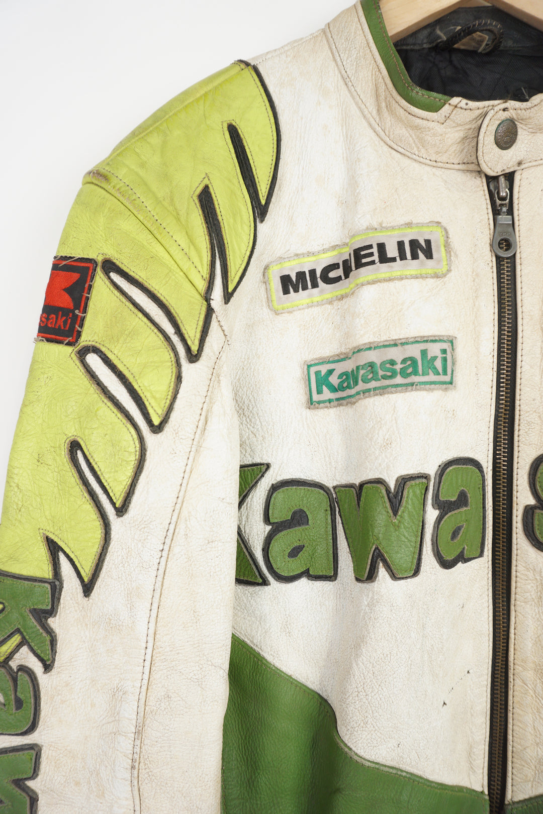 Vintage Kawasaki green & white leather motorcycle jacket features embroidered spell-out details, badges and sponsors