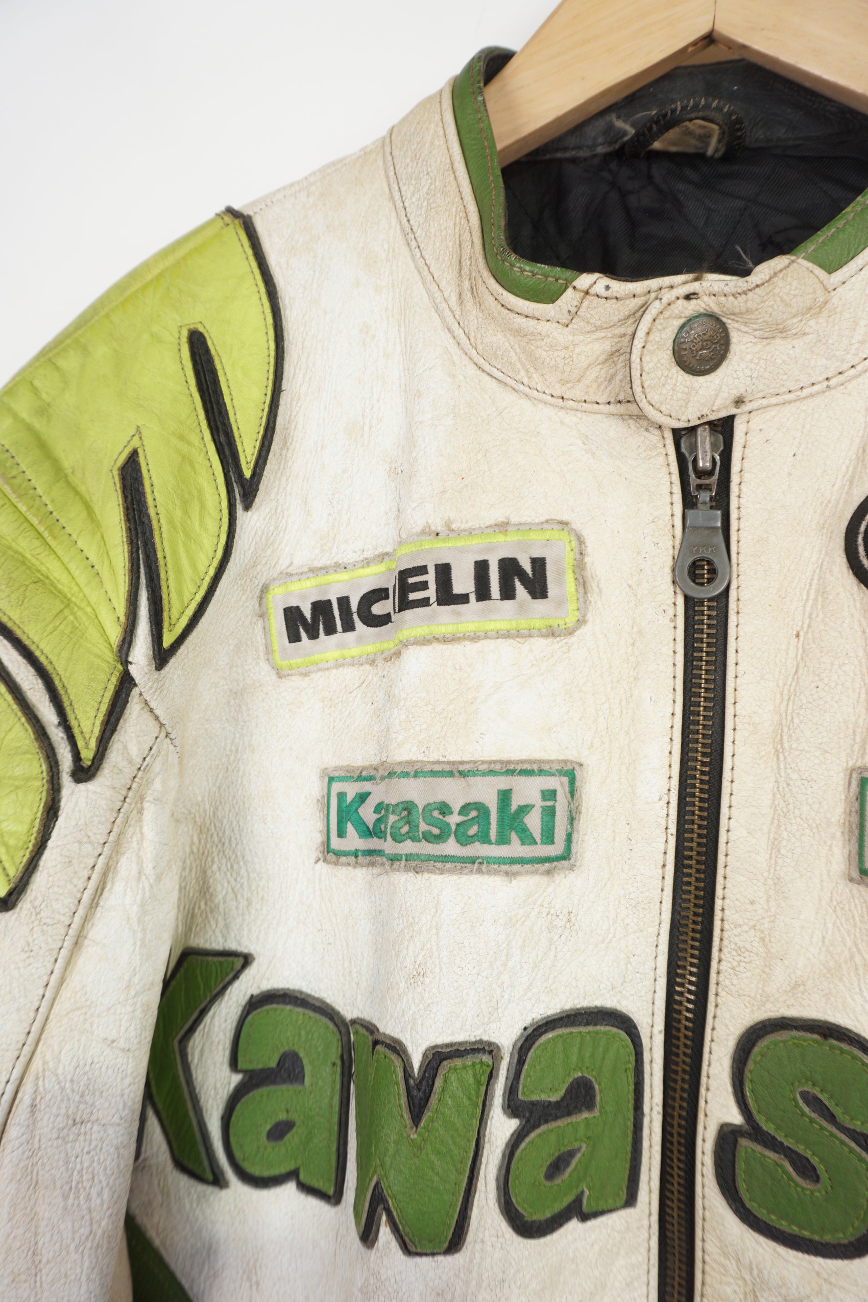 Vintage Kawasaki green & white leather motorcycle jacket features embroidered spell-out details, badges and sponsors