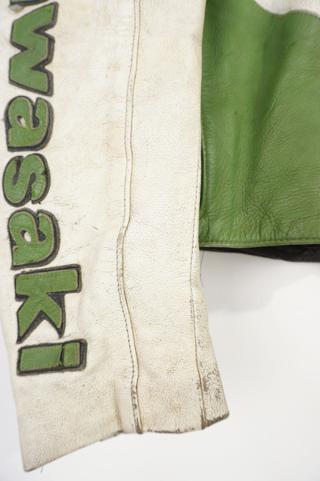 Vintage Kawasaki green & white leather motorcycle jacket features embroidered spell-out details, badges and sponsors