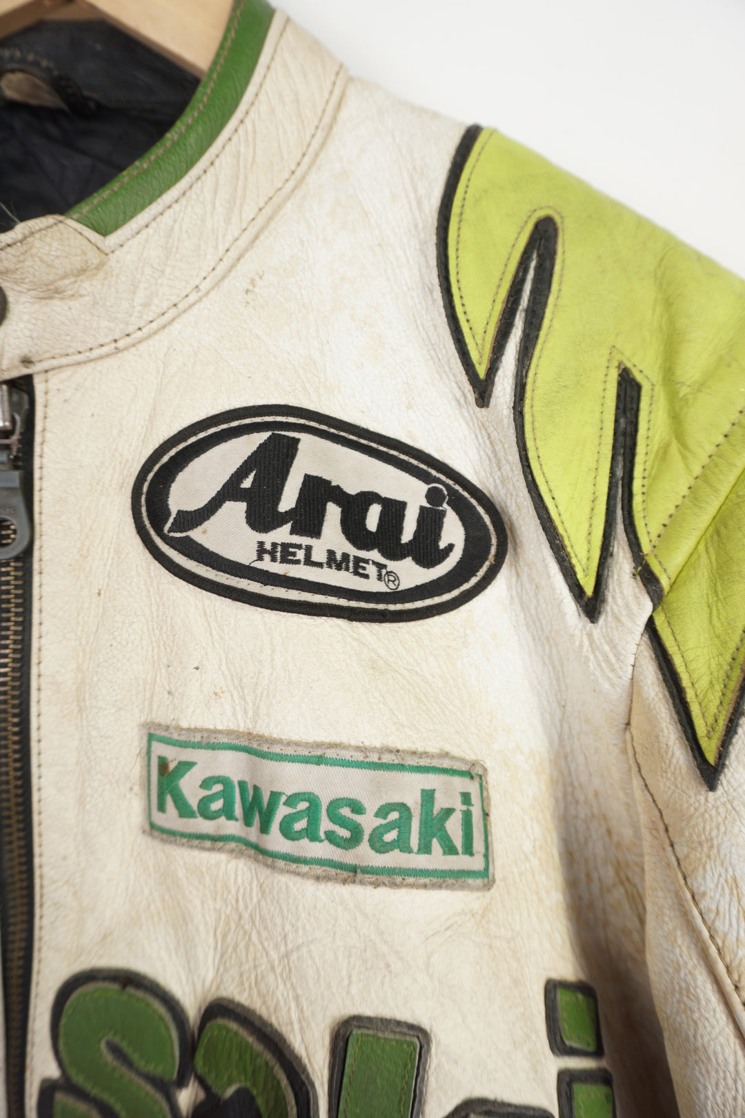 Vintage Kawasaki green & white leather motorcycle jacket features embroidered spell-out details, badges and sponsors