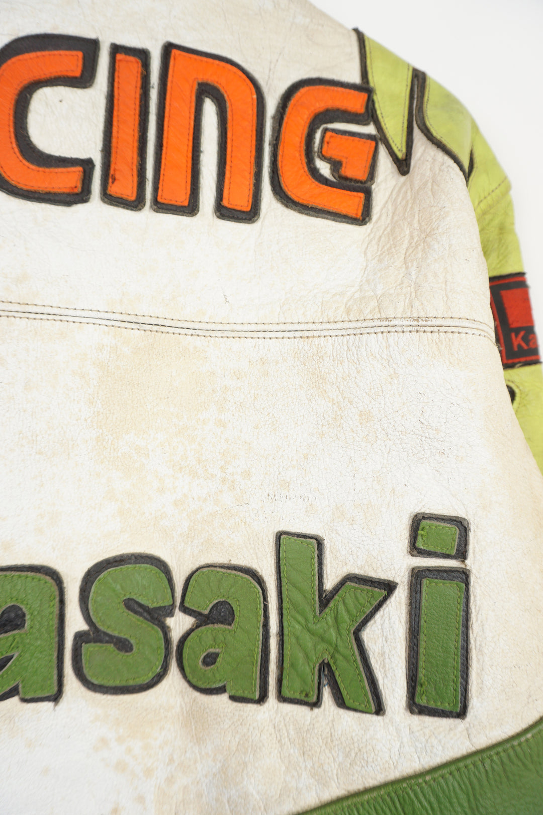 Vintage Kawasaki green & white leather motorcycle jacket features embroidered spell-out details, badges and sponsors