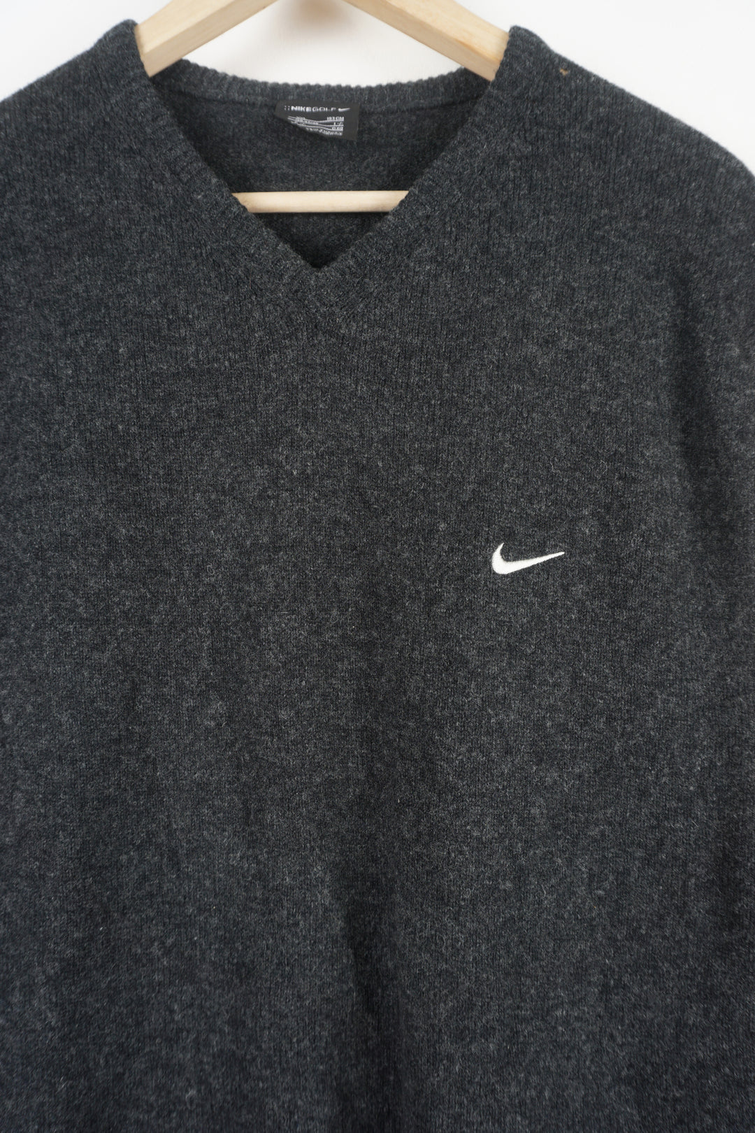 Dark grey Nike wool vest, features signature embroidered swoosh logo on the chest