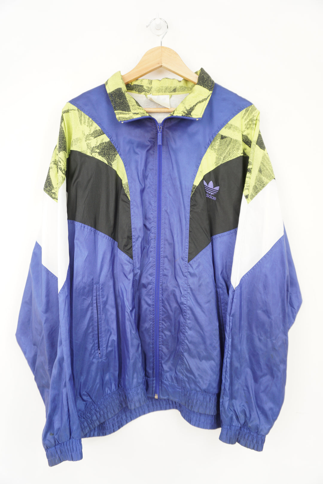 Purple and lime green 80's Adidas tracksuit top. Features embroidered spellout on the chest and full zip.