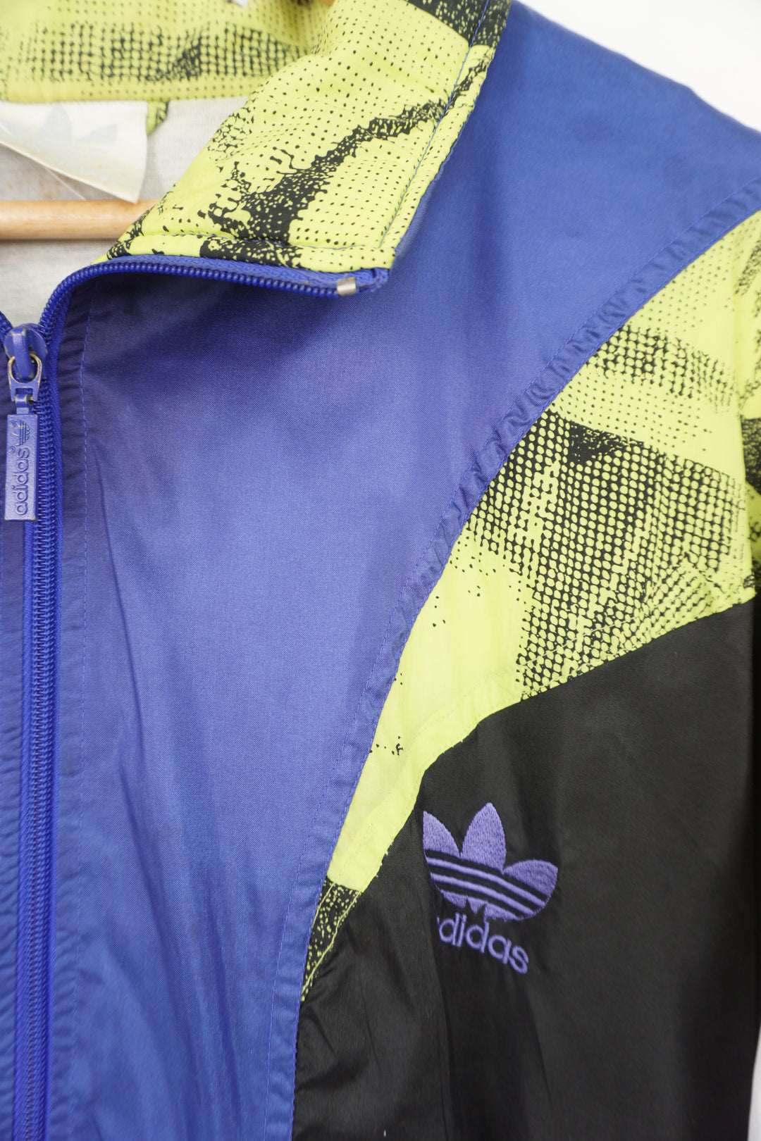 Purple and lime green 80's Adidas tracksuit top. Features embroidered spellout on the chest and full zip.