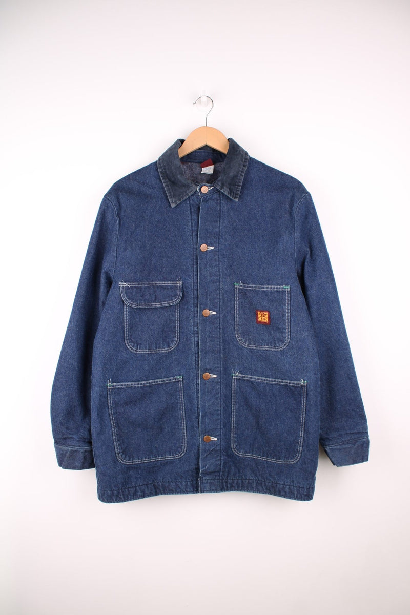 Big Ben by Wrangler Denim Chore Coat in a blue colourway with a corduroy collar, button up with multiple pockets, has a blanket lining, and the logo embroidered on the front. 