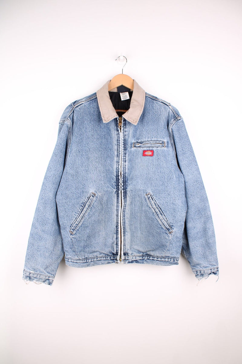 Dickies Denim Jacket in a light blue denim stonewash colourway with a beige corduroy collar, zip up with multiple pockets, has a quilted lining, and the logo embroidered on the front.