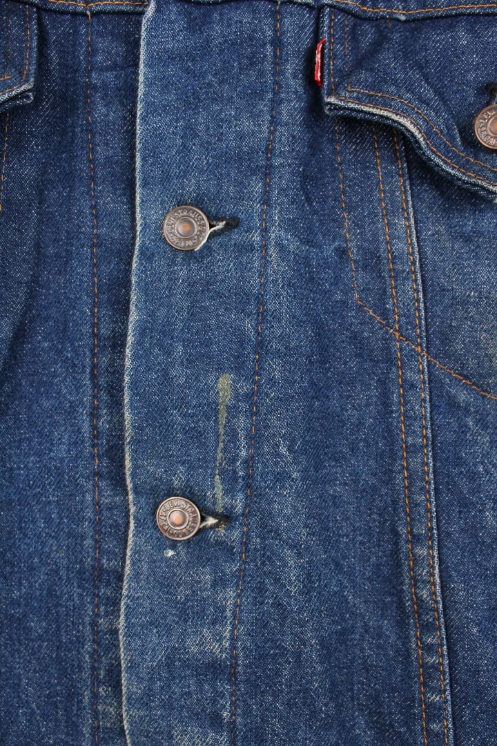 Levi's Denim Jacket in a blue colourway, button up with double chest pockets, has a blanket lining, and the logo embroidered on the front. 