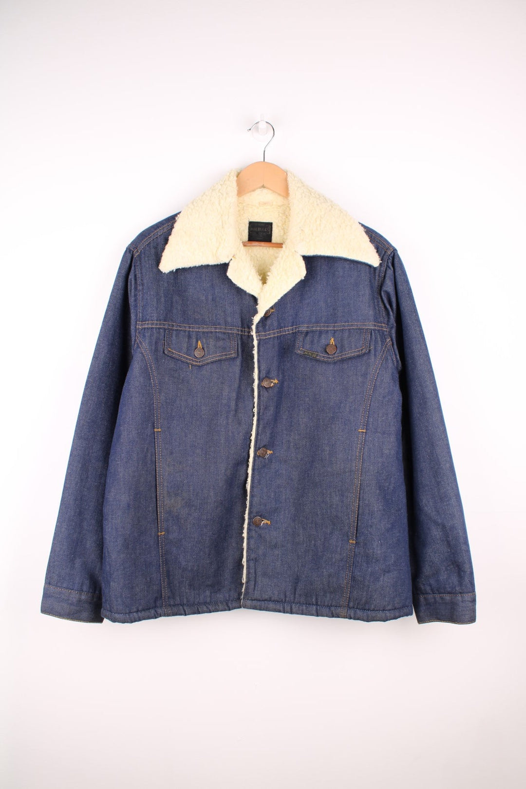 Vintage 70's Sears Roebuck Denim Sherpa Jacket in a blue colourway with a cream sherpa lining, button up with a camp collar, has multiple pockets and the logo embroidered on the front. 