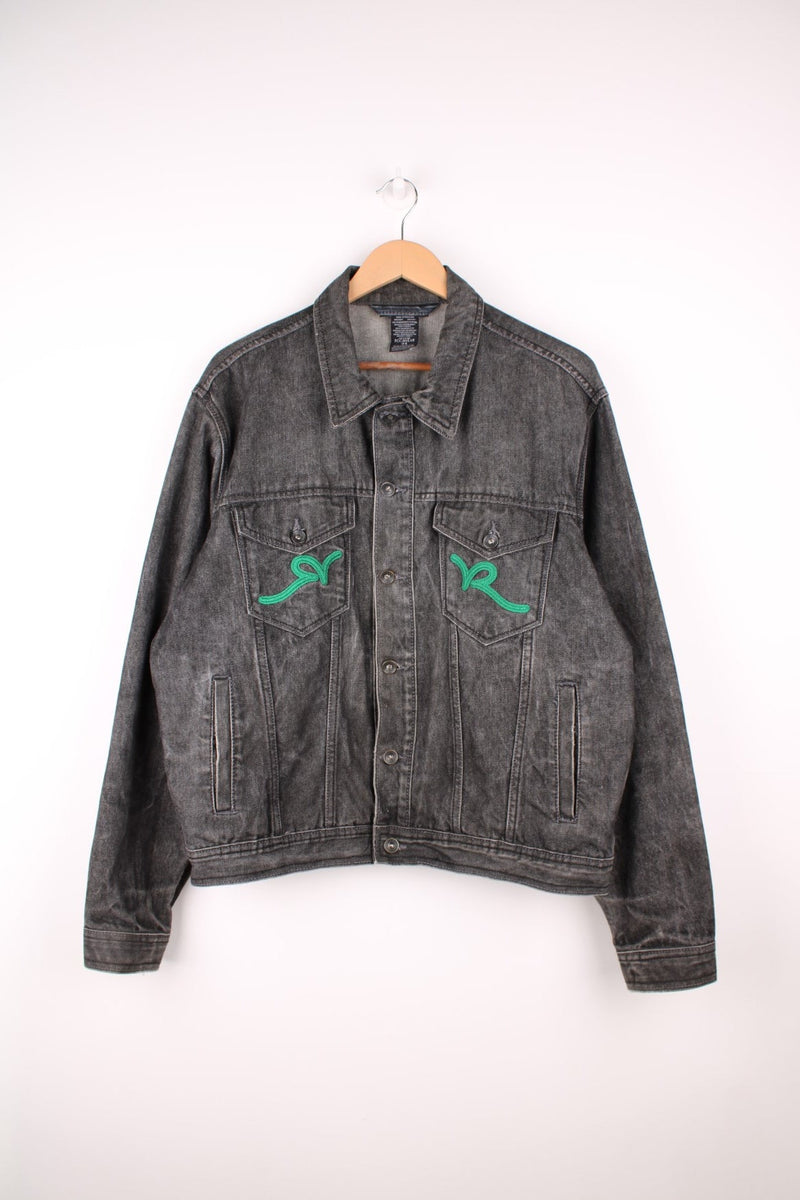 Y2K Rockawear Denim Jacket in a black colourway, button up with multiple pockets and has the logo embroidered on the double chest pockets. 