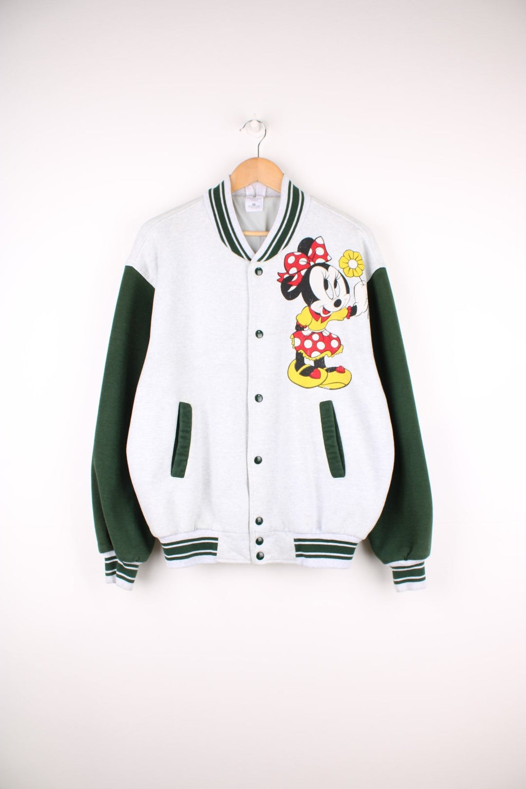 Vintage Disney Minnie Mouse Cotton Varsity Jacket in a grey and green colourway, button up with side pockets, has a nylon lining, and Minnie Mouse printed on the front. 