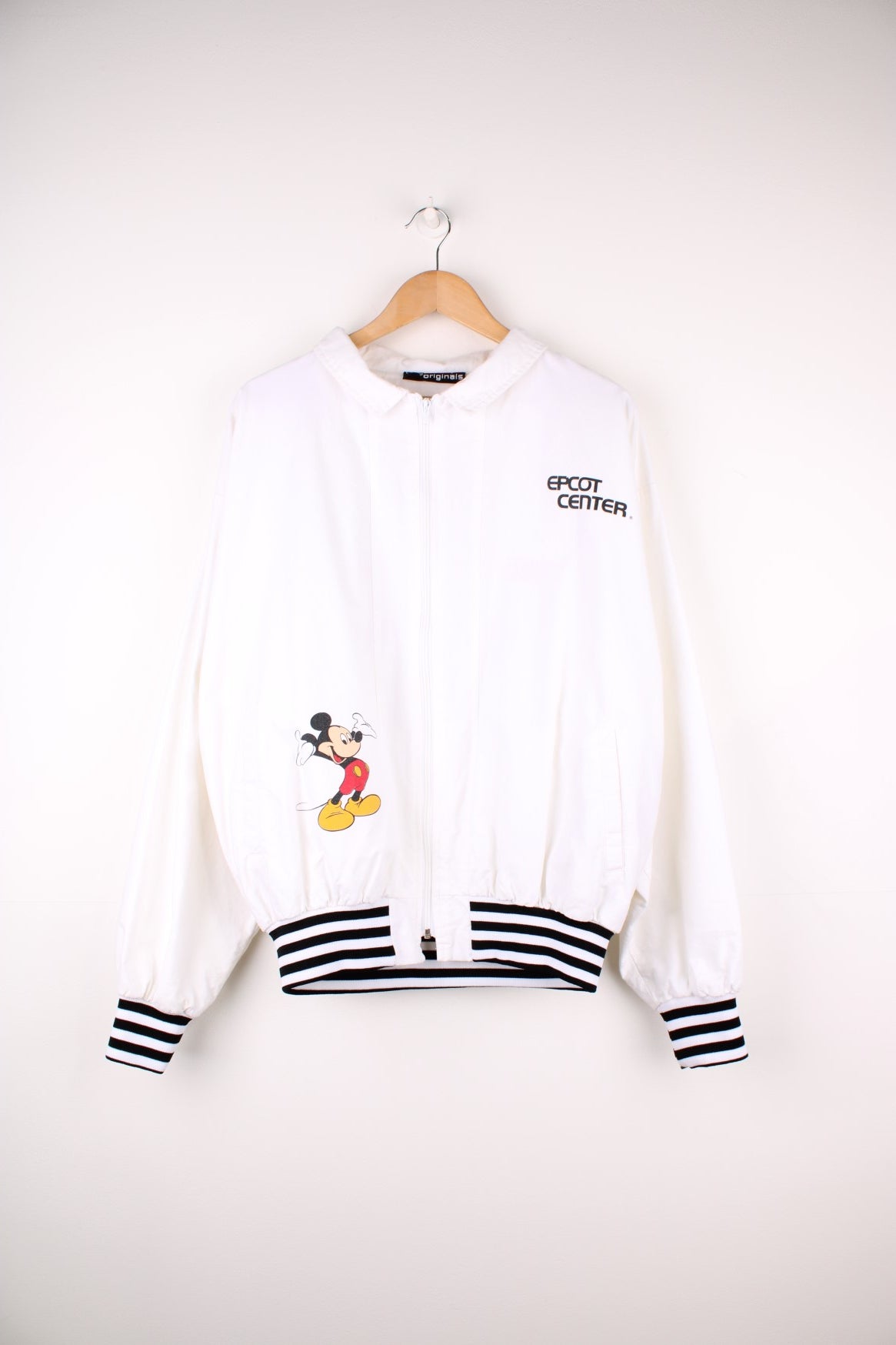 Disney Epcot Center Coach Jacket in a white and black colourway, zip up with side pockets, has a nylon lining, Mickey Mouse and the &