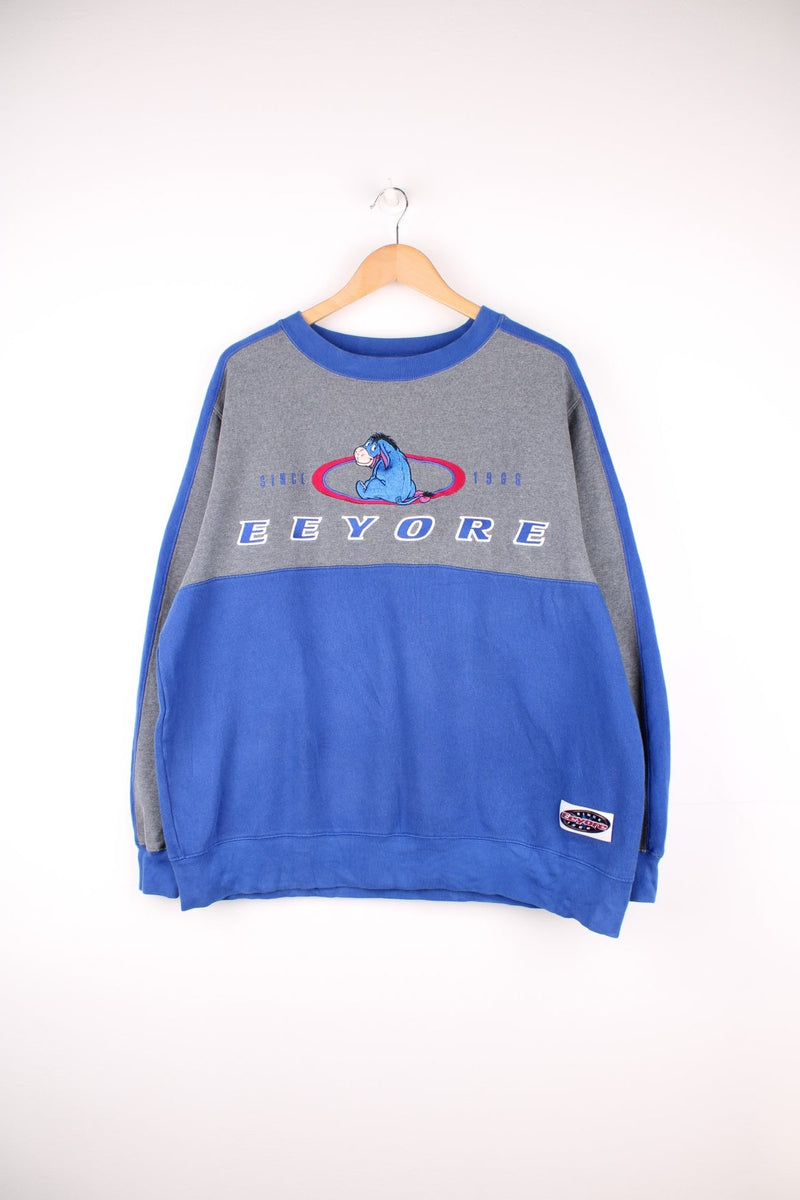 Disney Eeyore Sweatshirt in a blue and grey colourway with the spell out logo and Eeyore embroidered across the front.  