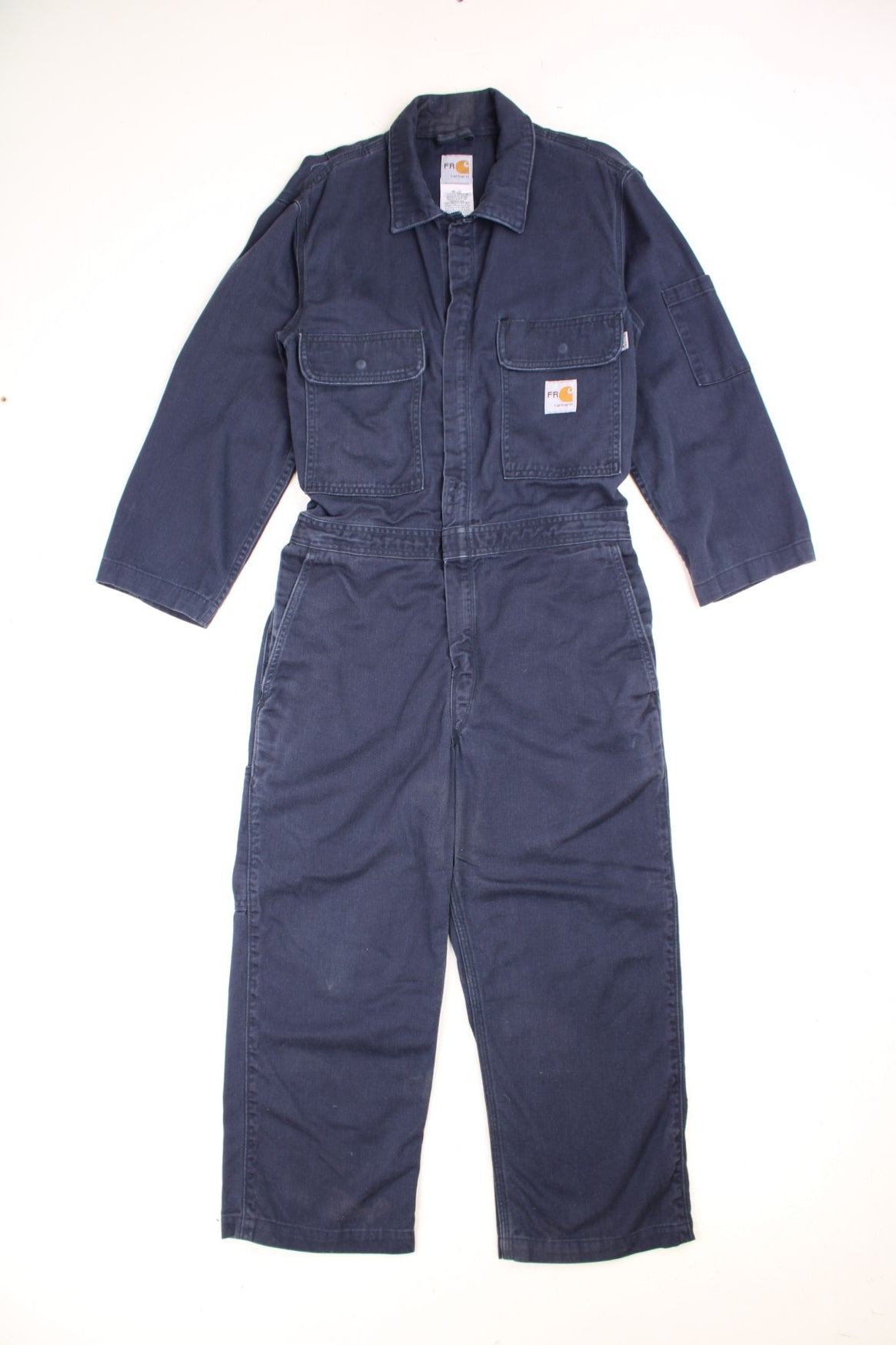 Vintage Carhartt Boiler Suit Overalls in a navy blue colourway, zip up with multiple utility pockets and has the logo embroidered on the chest. 