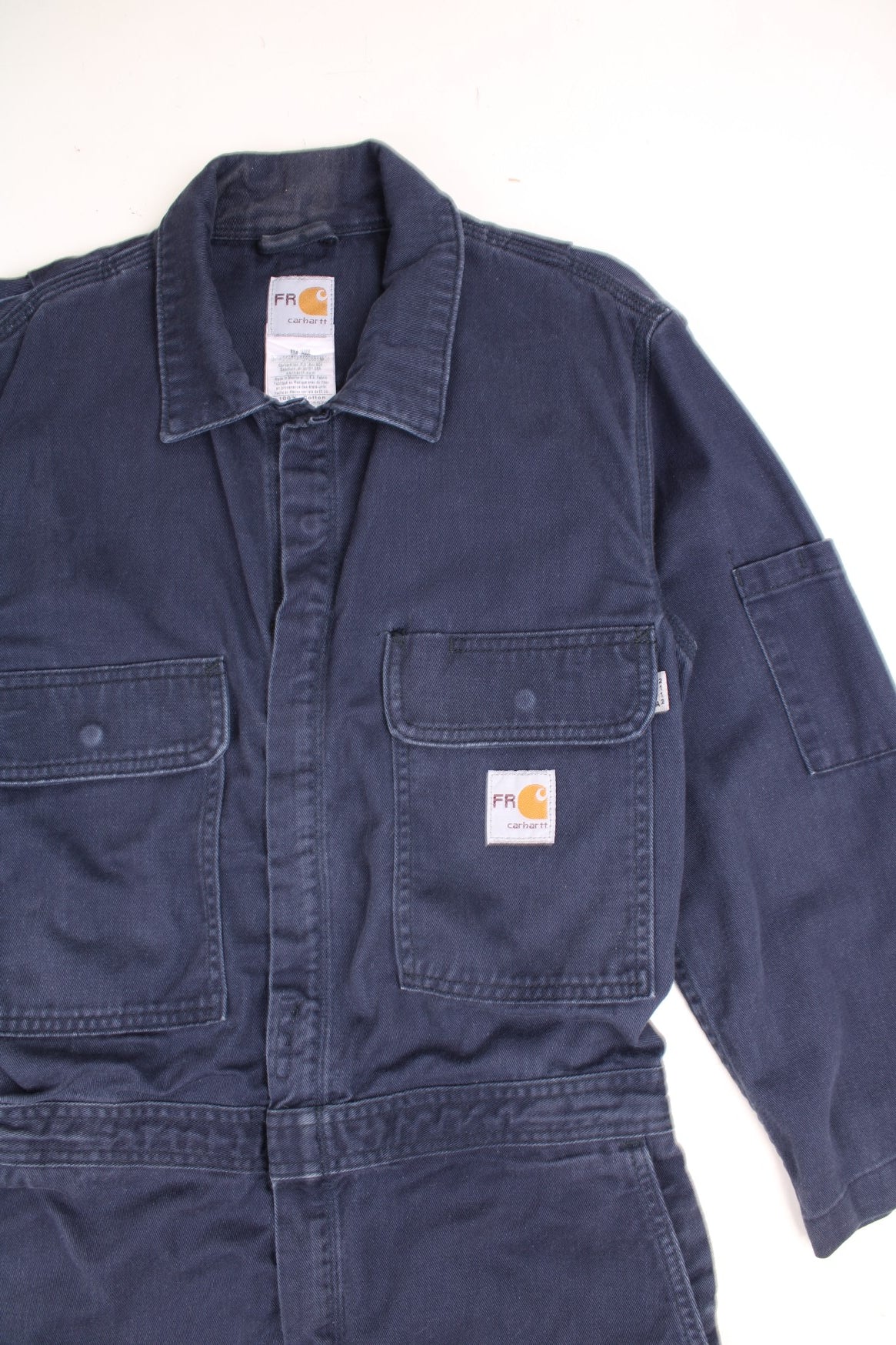 Vintage Carhartt Boiler Suit Overalls in a navy blue colourway, zip up with multiple utility pockets and has the logo embroidered on the chest. 