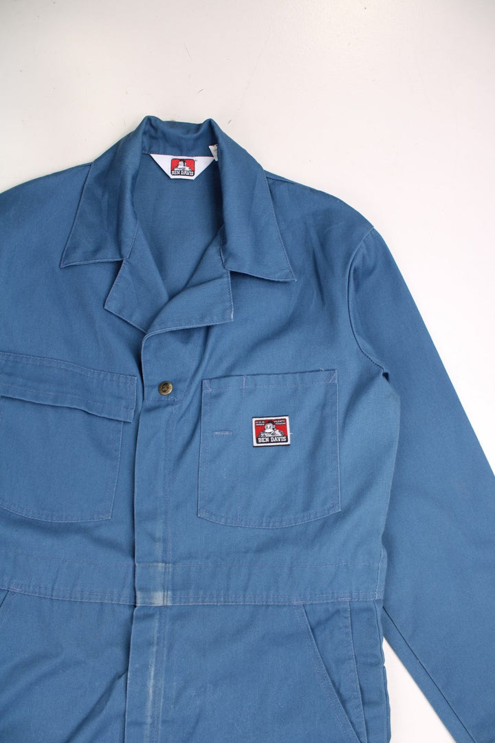 Ben Davies Boiler Suit Overalls in a blue colourway, zip up with multiple utility pockets and has the logo embroidered on the chest. 