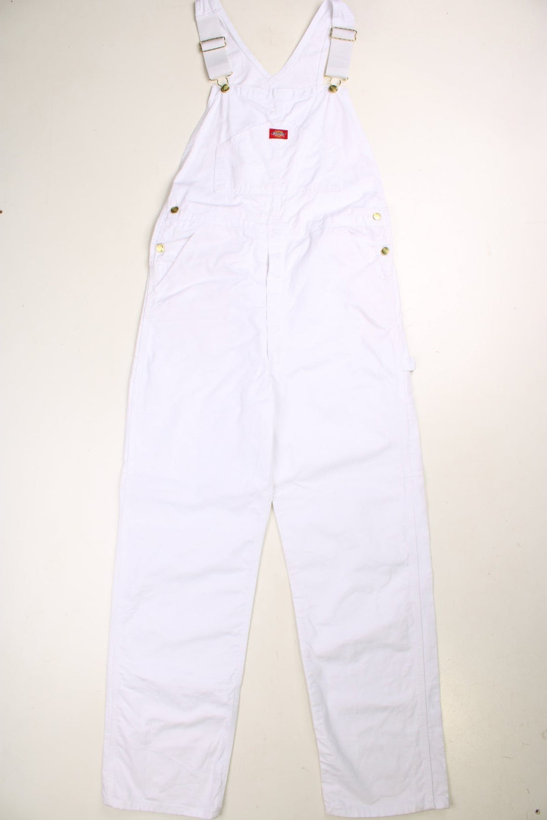 Dickies dungarees in white with multiple pockets and a red logo patch.