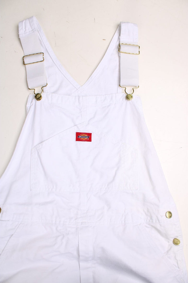 Dickies dungarees in white with multiple pockets and a red logo patch.